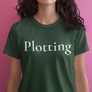 Plotting T-Shirt, Mischievous Humor Tee, Bold White Text Unisex Shirt