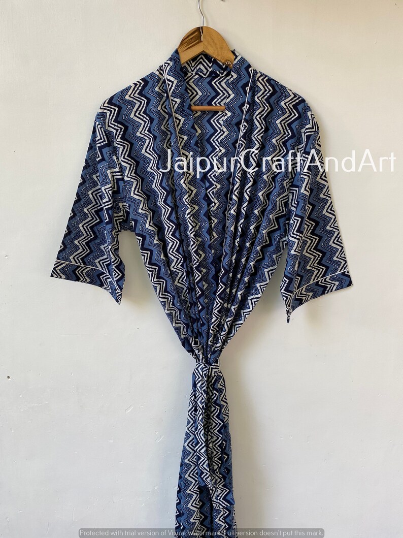 May include: A blue and white patterned cotton robe with a chevron design. The robe has a tie belt and long sleeves.