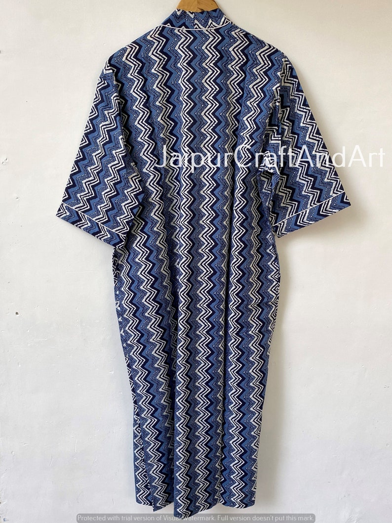 May include: A long blue and white cotton robe with a chevron pattern. The robe has a collar and three-quarter sleeves. The text "Jaipur CraftAndArt" is visible on the robe.