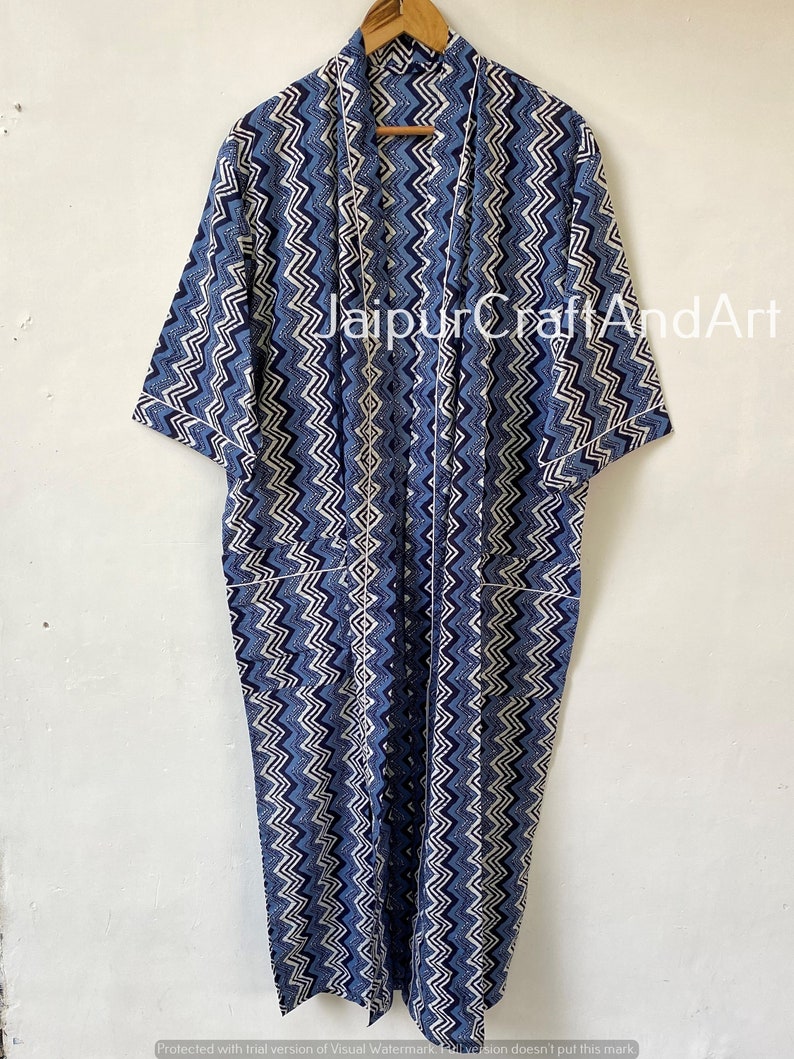 May include: A long blue and white patterned cotton robe with a white trim. The robe has a chevron pattern and is tied with a sash.