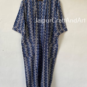 May include: A long, blue and white patterned robe with a chevron design. The robe has a shawl collar and short sleeves. The text "JaipurCraftAndArt" is visible on the robe.