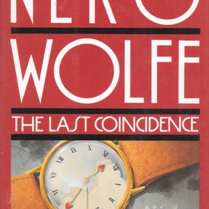 May include: A red book cover with the title "NERO WOLFE THE LAST COINCIDENCE" in white text. The author's name, "ROBERT GOLDSBOROUGH", is also in white text. A gold watch with a broken face is featured on the cover.