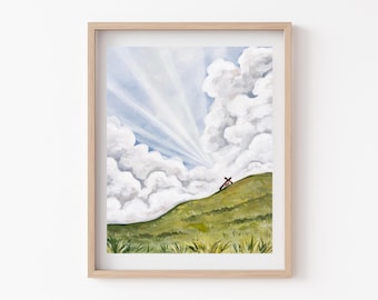 Peut inclure: Une impression d'art encadrée représentant une colline verte et herbeuse sous un ciel bleu vif rempli de grands nuages blancs et de rayons de soleil. Une petite croix brune se dresse sur la pente. Le cadre est en bois clair.