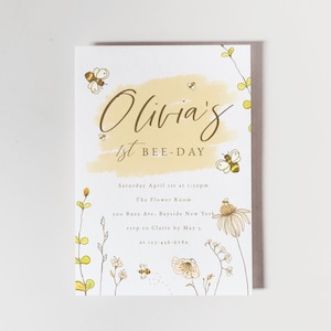 May include: A yellow and white invitation with a watercolour background and the text "Olivia's 1st BEE-DAY". The invitation includes details for a party on Saturday, 1st April at 1:30pm at The Flower Room, 100 Buzz Ave, Bayside New York. RSVP to Claire by 5th May at 123-456-6789.
