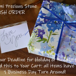 May include: A gift wrapped in floral paper with blue ribbon and a small card that says "Love You". The text on the image says "The Semi Precious Stone RUSH ORDER".