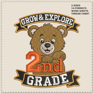May include: An embroidery design featuring a brown bear cub centered between two black banners with gold trim. The top banner reads GROW & EXPLORE, and the bottom reads 2nd GRADE in white text. A large orange 2nd is positioned over the bear's chest.