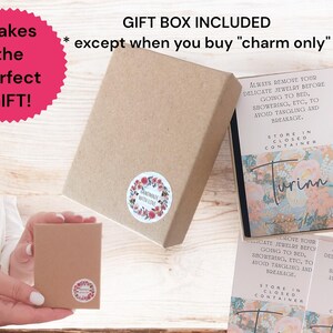 May include: A brown gift box with a floral sticker that says "Handmade with Love". The box is open and shows a smaller brown box inside. The smaller box has a sticker that says "Store in closed container". The image also includes a card with the text "Always remove your delicate jewelry before going to bed, showering, etc., to avoid tangling and breakage. Store in closed container". The card has a floral design and the text "Turinn meaning "gift".