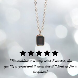 May include: A delicate gold chain necklace with a small black rectangular pendant. The necklace is rated five stars with the text "The necklace is exactly what I wanted, the quality is great and it seems like it'll hold up for a long time."