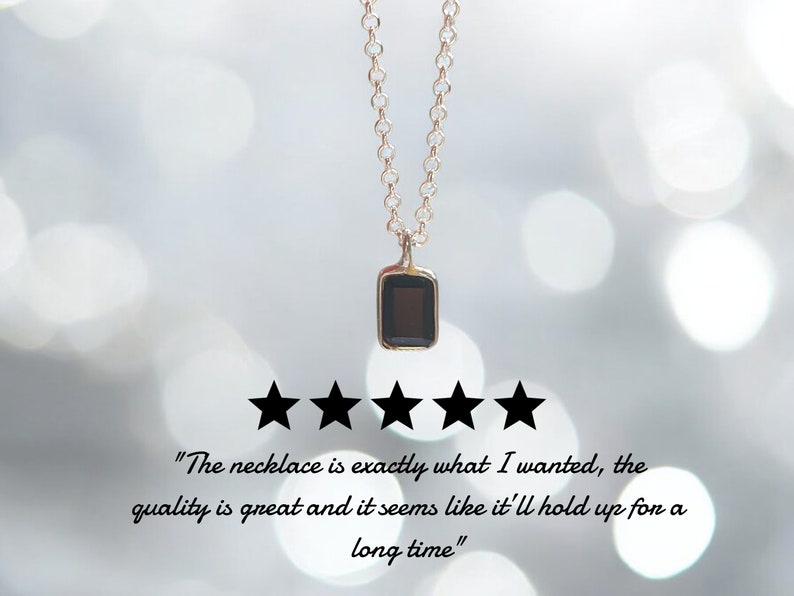 May include: A delicate gold chain necklace with a small black rectangular pendant. The necklace is rated five stars with the text "The necklace is exactly what I wanted, the quality is great and it seems like it'll hold up for a long time."