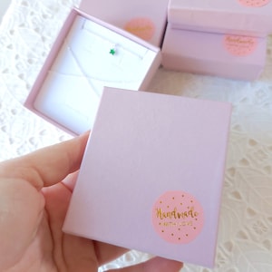May include: A pink gift box with a gold sticker that says "Handmade with Love". The sticker is a circle with gold hearts around the edge.