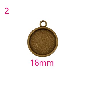 May include: A round, 18mm, antique brass pendant with a smooth, textured surface. The pendant has a loop at the top for attaching a chain or cord.