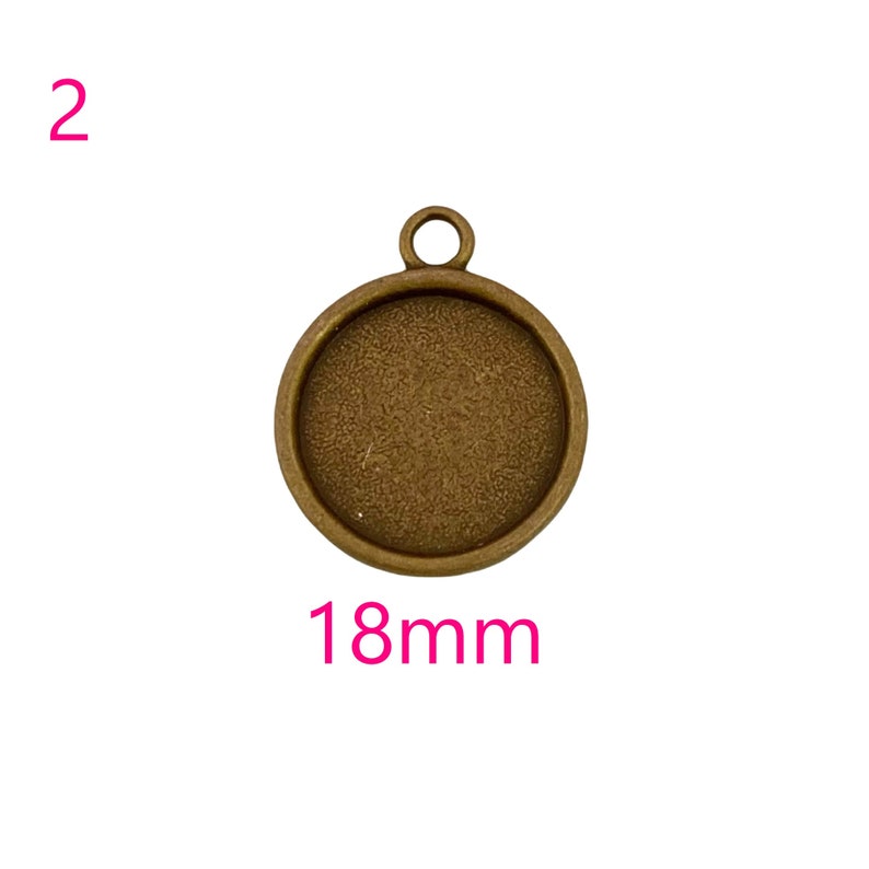 May include: A round, 18mm, antique brass pendant with a smooth, textured surface. The pendant has a loop at the top for attaching a chain or cord.