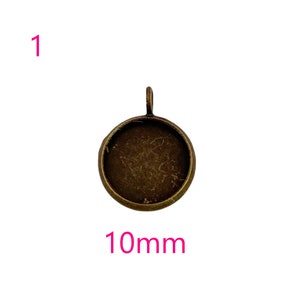 May include: A 10mm round metal pendant tray with a bronze finish. The tray has a loop at the top for attaching a chain or cord.