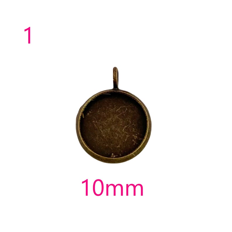 May include: A 10mm round metal pendant tray with a bronze finish. The tray has a loop at the top for attaching a chain or cord.
