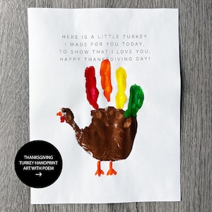 May include: Thanksgiving-themed handprint art on white paper. A brown handprint forms the turkey's body, with colorful finger-painted feathers in red, orange, yellow, and green. The artwork includes a poem and the text "Thanksgiving Turkey Handprint Art with Poem."