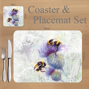 May include: Coaster and placemat set with a watercolour design of bumblebees on purple thistle flowers. The placemat measures 29cm x 21.5cm, and the coaster is 9cm x 9cm. The set includes a fork and knife.