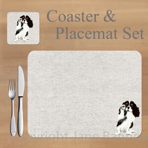 Könnte beinhalten: Ein Untersetzer- und Platzset-Set mit einer Illustration eines Cavalier King Charles Spaniel. Das Set enthält einen quadratischen Untersetzer und einen rechteckigen Platzset, beide mit einer hellbeigen Leinenstruktur. Der Text "Coaster & Placemat Set" ist grau dargestellt.