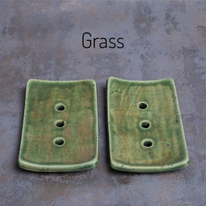 Grass has a mixture of greens and browns in varying intensities.