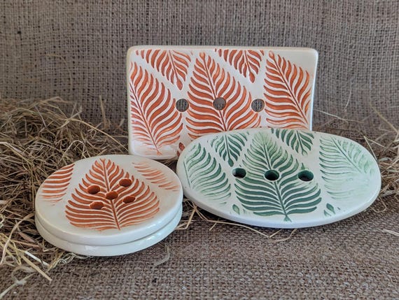 Ceramic soap dish embossed with a leaf design.