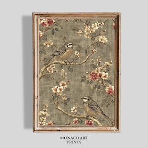May include: A framed print featuring two birds perched on flowering branches. The artwork has a vintage aesthetic, with a muted color palette of greens, browns, and touches of red. The text "MONACO ART PRINTS" is at the bottom.