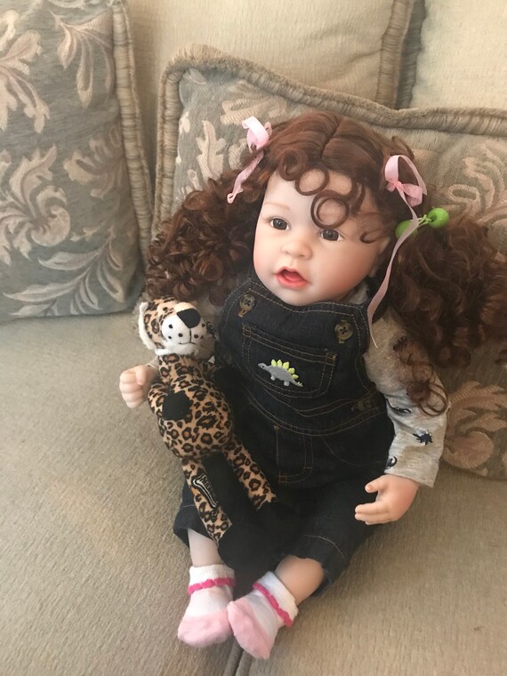 doll with brown curly hair and brown eyes