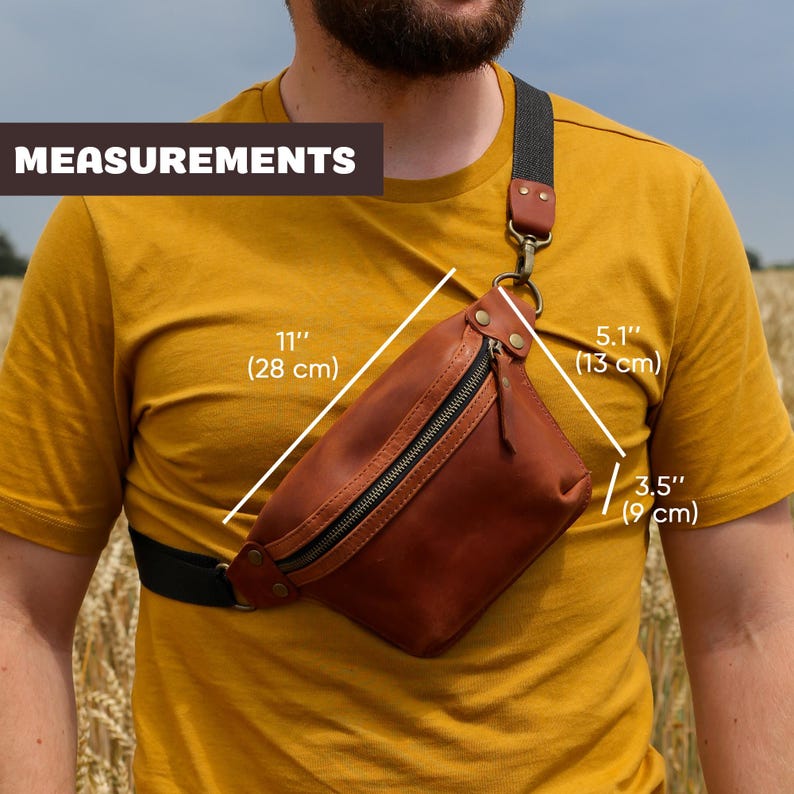 May include: A brown leather fanny pack with a zippered pocket and a black strap. The bag measures 11 inches wide, 5.1 inches tall, and 3.5 inches deep.