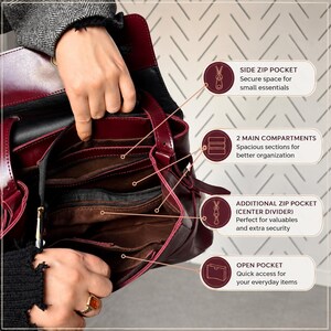 May include: A deep burgundy handbag with a dark brown interior featuring multiple organizational sections including a side zip pocket, two main compartments, a center divider zip pocket, and an open pocket for storage of various items.