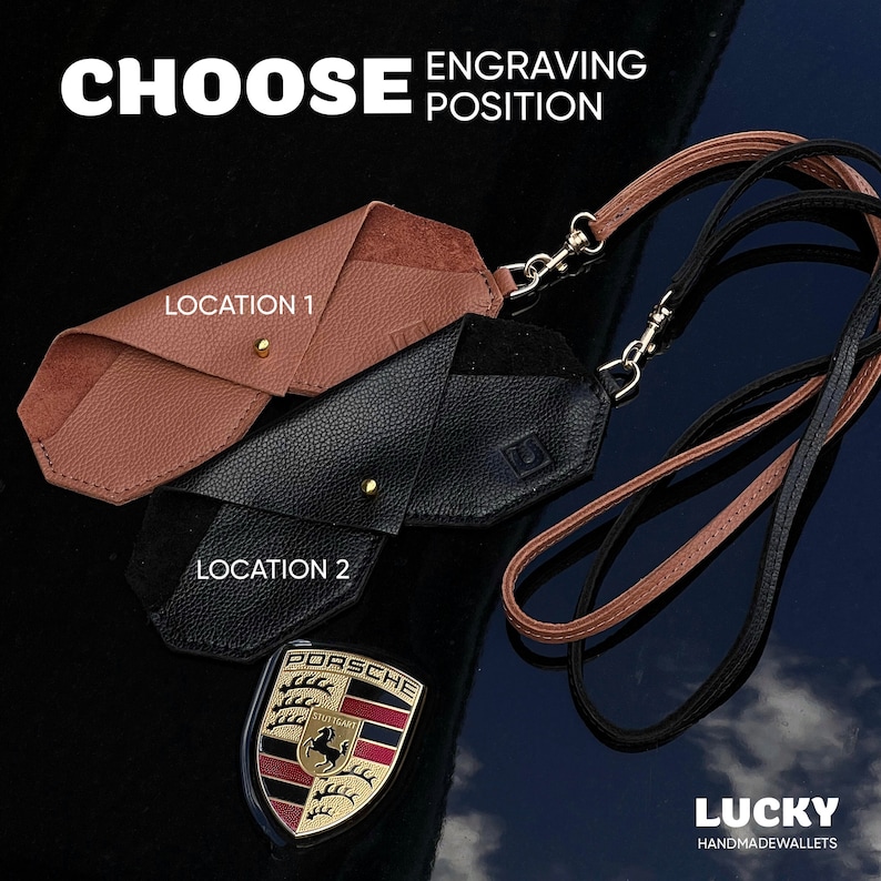 May include: Two leather keychains with a choice of engraving locations marked "Location 1" and "Location 2". The keychains are brown and black and have a gold metal clasp. The text "Choose Engraving Position" is at the top of the image. The image also includes a Porsche logo.
