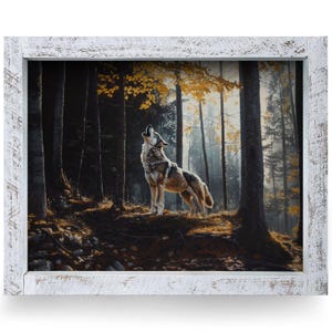 May include: A framed print depicts a howling wolf in a forest scene. The artwork features a gray and brown wolf standing on a hill, surrounded by tall trees and autumn foliage. The frame is white with a distressed finish.