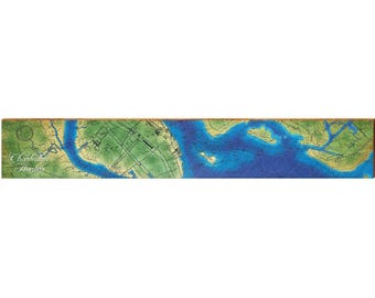 May include: A rectangular wooden wall art piece featuring a detailed nautical map of Charleston Harbor. The map displays deep blue water depths, green land masses, and navigational lines, with the text Charleston Harbor printed in white.