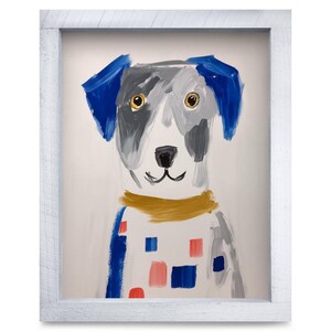 May include: A framed painting of a dog with blue ears, a gray and white face, and golden yellow collar. The dog's body features blue and coral square patterns on a white background. The artwork is enclosed in a white wooden frame.
