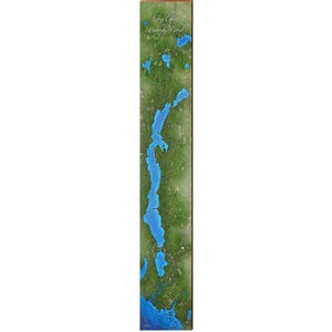 May include: A vertical wooden sign featuring a map of Long Lake and Brandy Pond. The map shows a long, blue lake surrounded by green land. The text "Long Lake and Brandy Pond" is at the top in a cursive font.