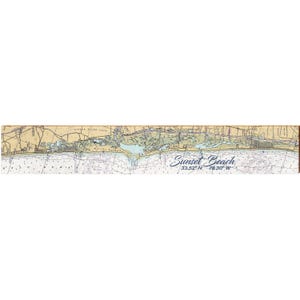 May include: A nautical chart of Sunset Beach, North Carolina, with the text "Sunset Beach" in a cursive font. The map features land, water, and navigational details in shades of beige, blue, and white. Coordinates 33.52° N 78.30° W are also included.