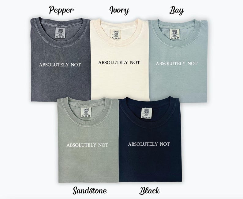 May include: Five t-shirts in different colours, including pepper, ivory, bay, sandstone, and black. Each shirt has the text "ABSOLUTELY NOT" printed on the front.