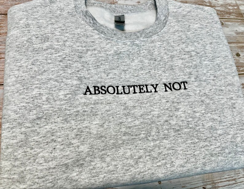 May include: A gray heather sweatshirt with the text "ABSOLUTELY NOT" embroidered in black.