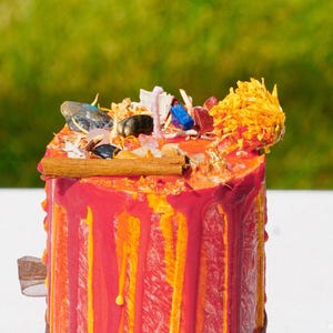 Top of Lammas pillar candle decorated with crystals and herbs