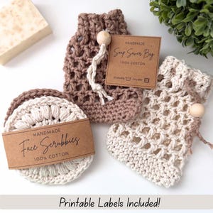 May include: Handmade crochet face scrubbies and soap saver bags in cream and brown. The face scrubbies are round, and the bags have a drawstring closure with a wooden bead. Each item has a brown tag that reads "Handmade Face Scrubbies 100% Cotton" and "Soap Saver Bag 100% Cotton".