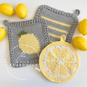 May include: Three crocheted lemon-themed pot holders. One pot holder is gray with a yellow lemon, another is gray with yellow stripes, and the third is yellow with a white center and a white border.