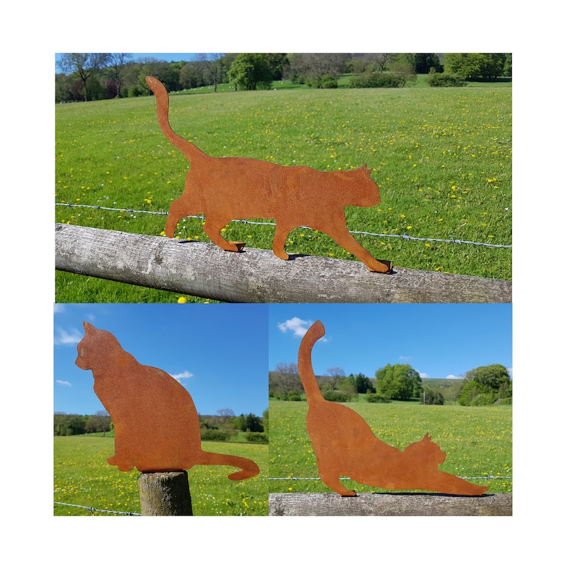 May include: Three rusty metal cat silhouettes in different poses. The cat silhouettes are placed on wooden fence posts in a grassy field.
