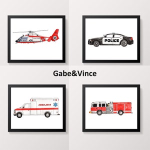 May include: Four framed watercolour prints of emergency vehicles. Includes a red and white Coast Guard helicopter, a black police car with "POLICE", a white and red ambulance, and a red fire engine.