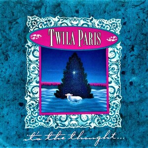 May include: Album cover art featuring the text "TWILA PARIS" in pink and white, set against a blue background. The image inside the frame shows a dark blue Christmas tree, a white sheep, and a starry night sky. The words "it's the thought..." are written at the bottom.