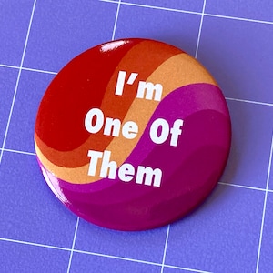 May include: A red, orange, and pink button with a white background and the text "I'm One Of Them" in white.