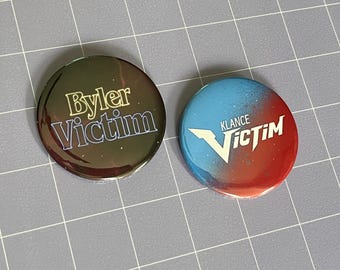 Ship Victim 2.25" Pin-Back Buttons (Choose One)