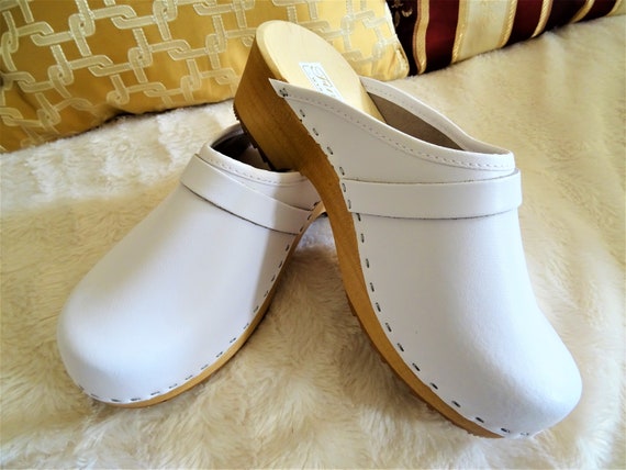 white wooden clogs