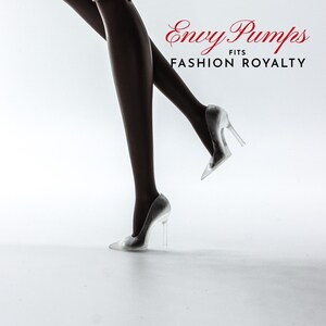 May include: A pair of silver high-heeled shoes with clear heels. The shoes are on a white background. The text "Envy Pumps FITS FASHION ROYALTY" is visible in the top right corner of the image.