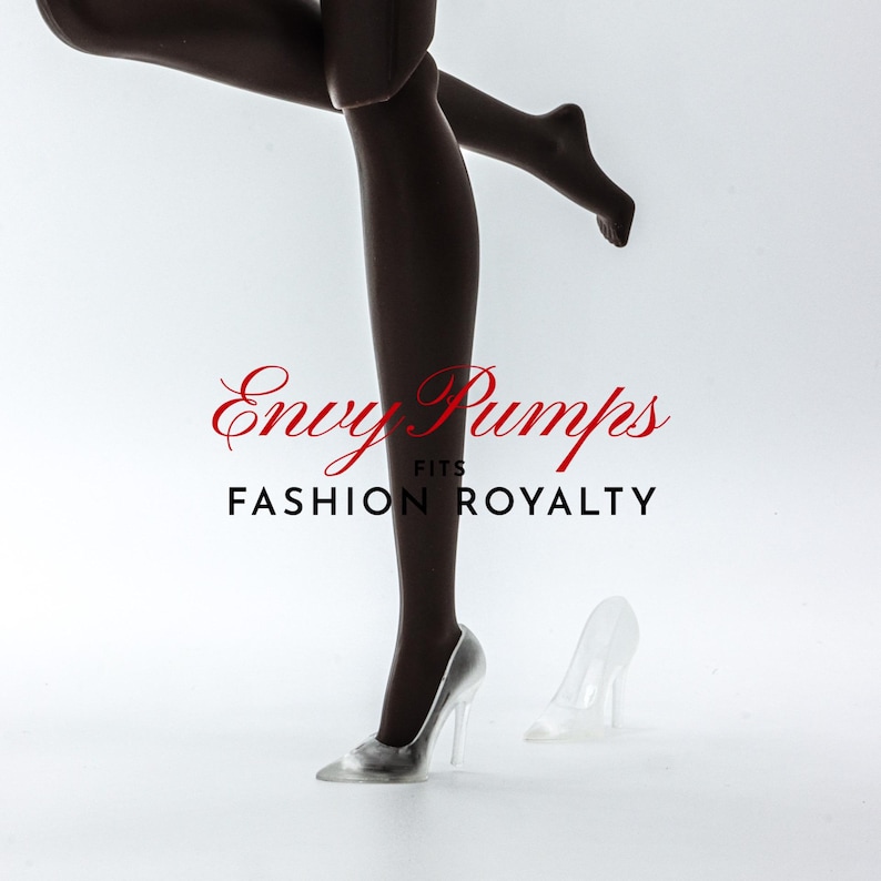 May include: A pair of clear glass high-heeled shoes. The shoes are on a white surface. The text "Envy Pumps Fits Fashion Royalty" is visible in the image.