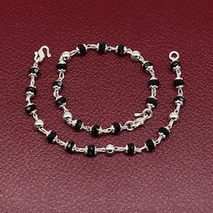 Silver baby bracelets with top black beads