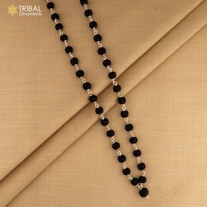 May include: A black beaded necklace with silver-toned chain links. The necklace features round, matte black beads. The Tribal Ornaments logo is in the upper left corner.