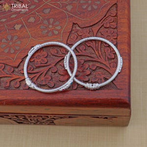 May include: A rustic wooden sign with the text "Welcome to our home" in white lettering. The sign has a distressed finish and a simple, inviting design, suitable for a front porch or entryway.