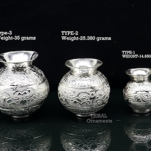 May include: Three silver decorative pots with intricate designs. The largest pot weighs 35 grams, the middle pot weighs 25.380 grams, and the smallest pot weighs 14.650 grams.